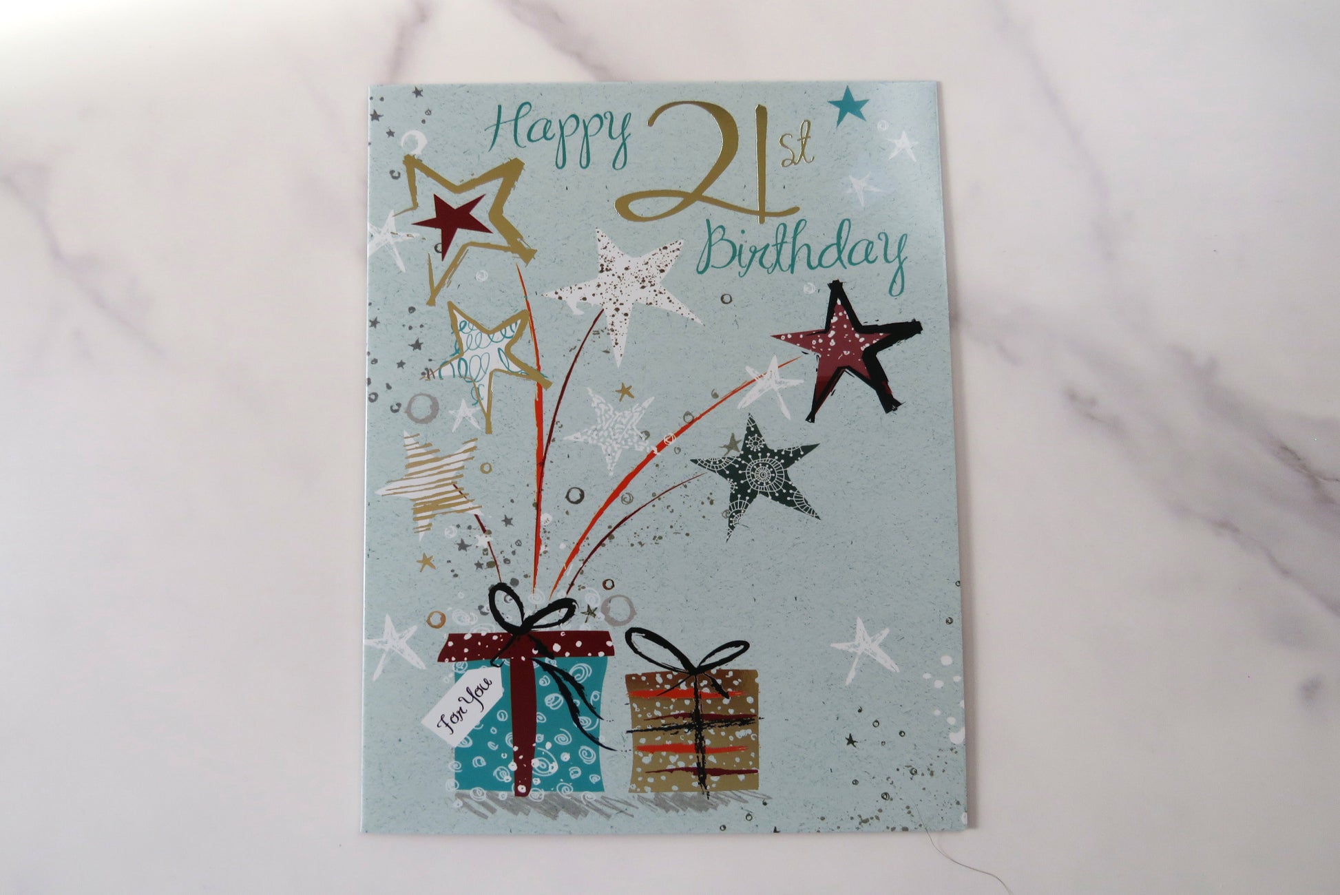 Happy 21st birthday card with stars and gift boxes.