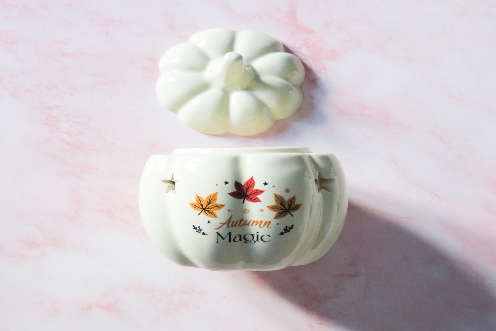 White ceramic pumpkin-shaped wax / oil burner with 'Autumn Magic' text and leaf designs.