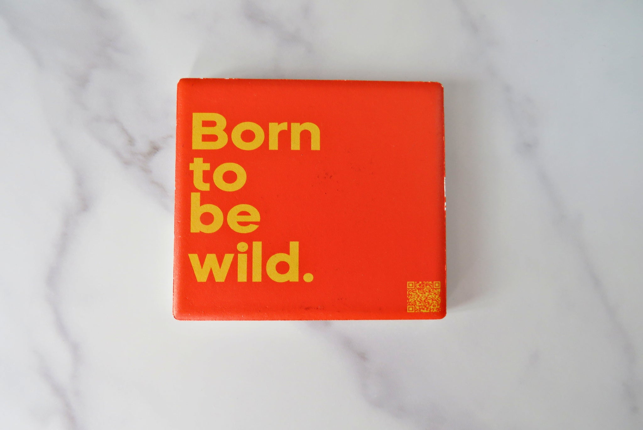 A red square magnet with born to be wild text on.