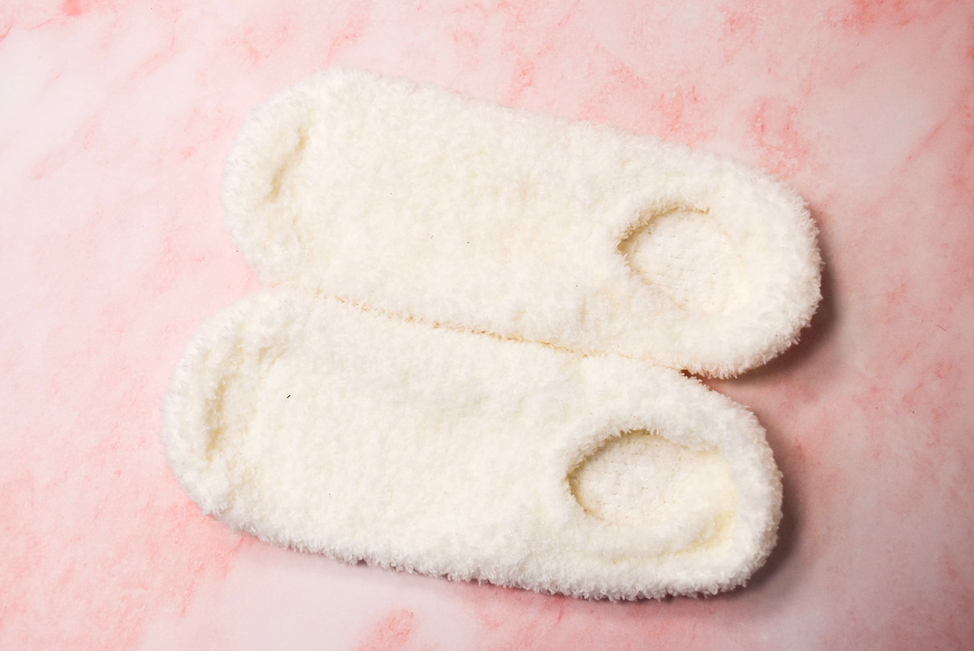 A pair of white slippers socks.