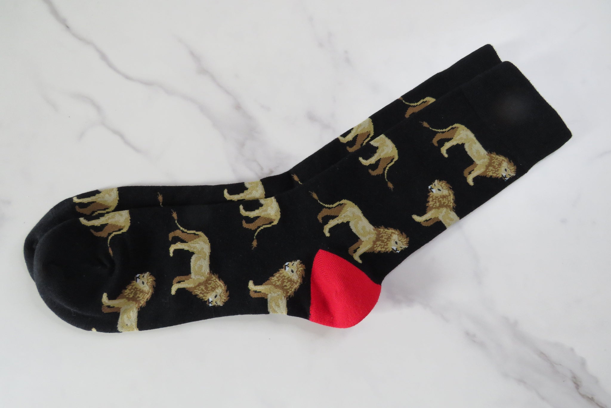A pair of men's black socks with lions on.