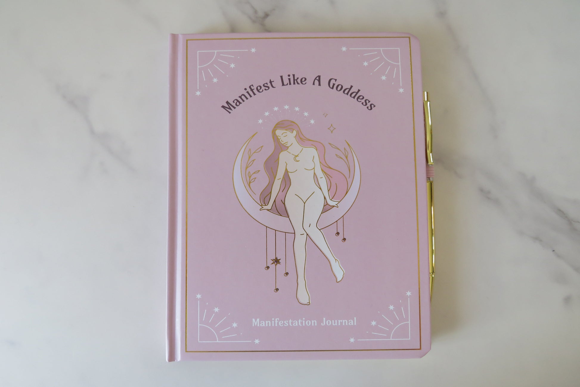 Manifest like a goddess journal with a gold cover and woman illustration & gold pen.