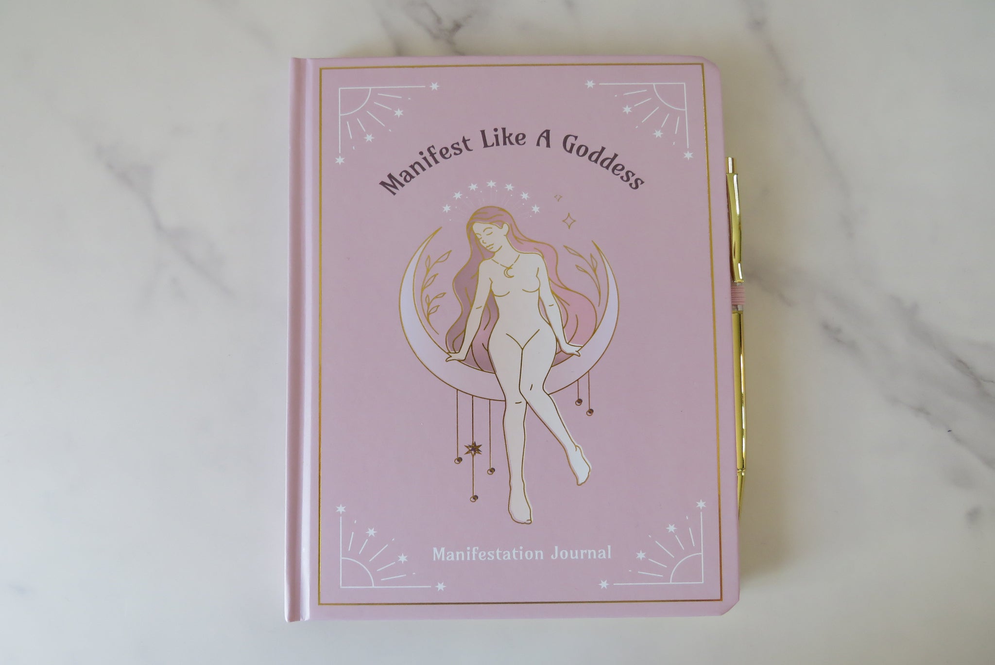 Manifest like a goddess journal with a gold cover and woman illustration & gold pen.