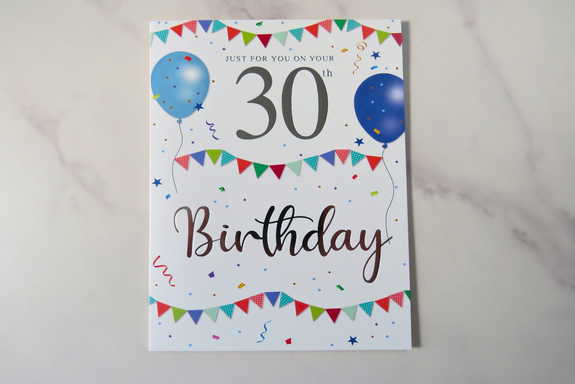 A 30th birthday card with colorful party decorations and the number 30 prominently displayed.