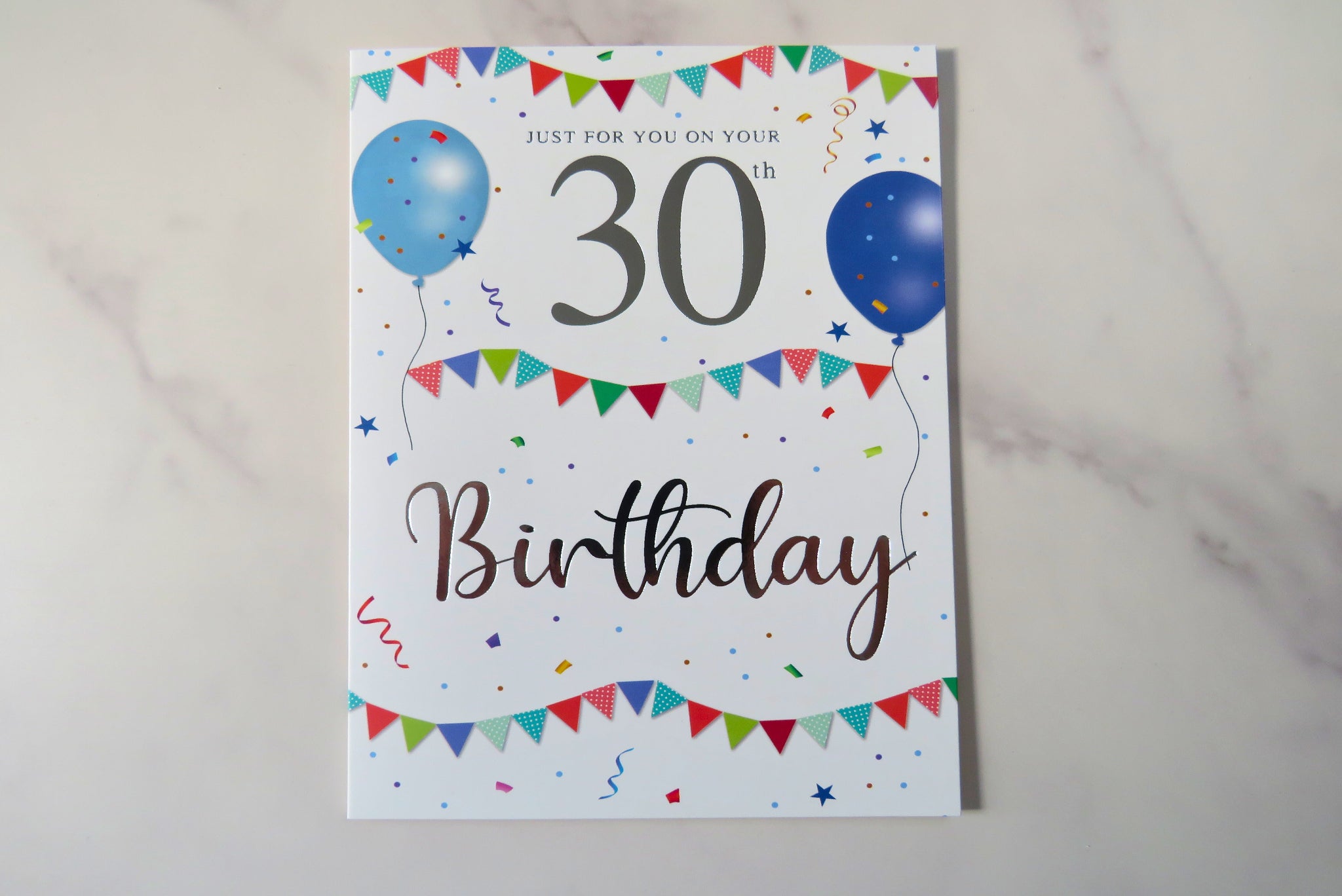 A 30th birthday card with colorful party decorations and the number 30 prominently displayed.