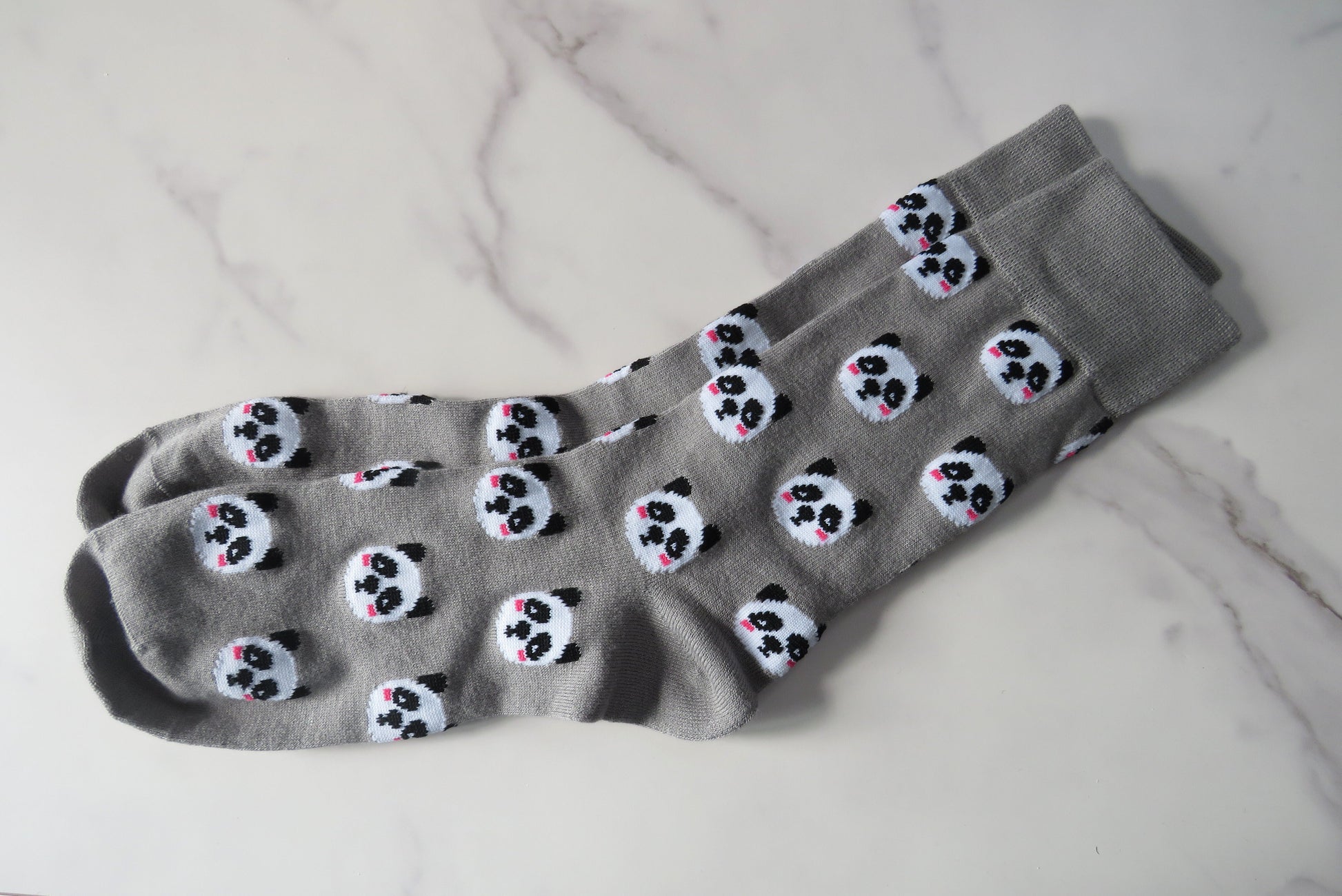 grey women's socks with pandas on.
