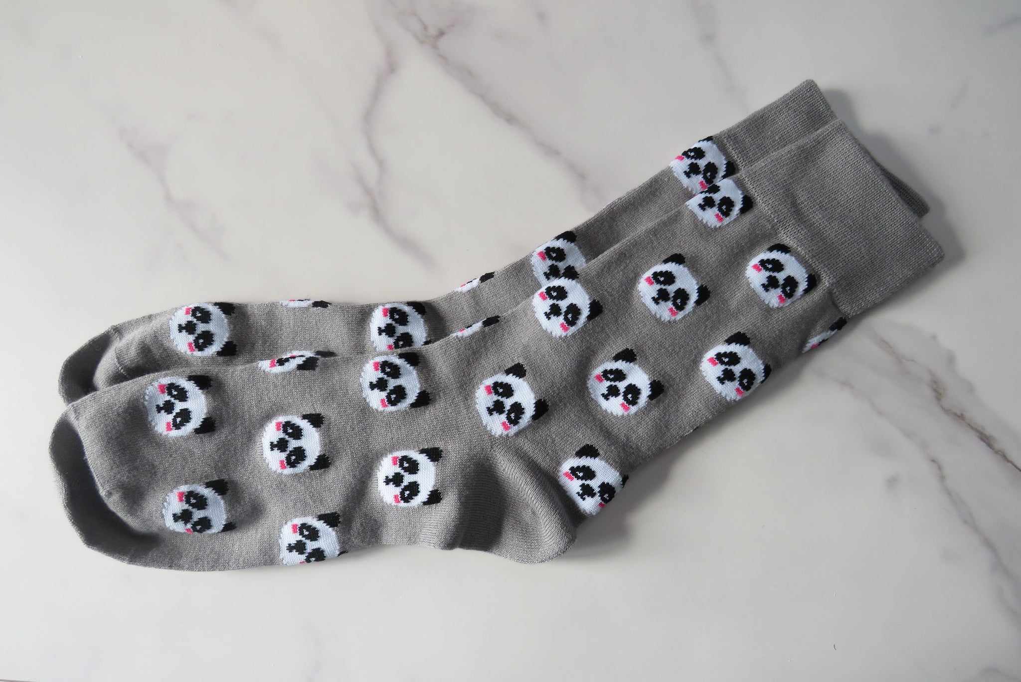 grey women's socks with pandas on.