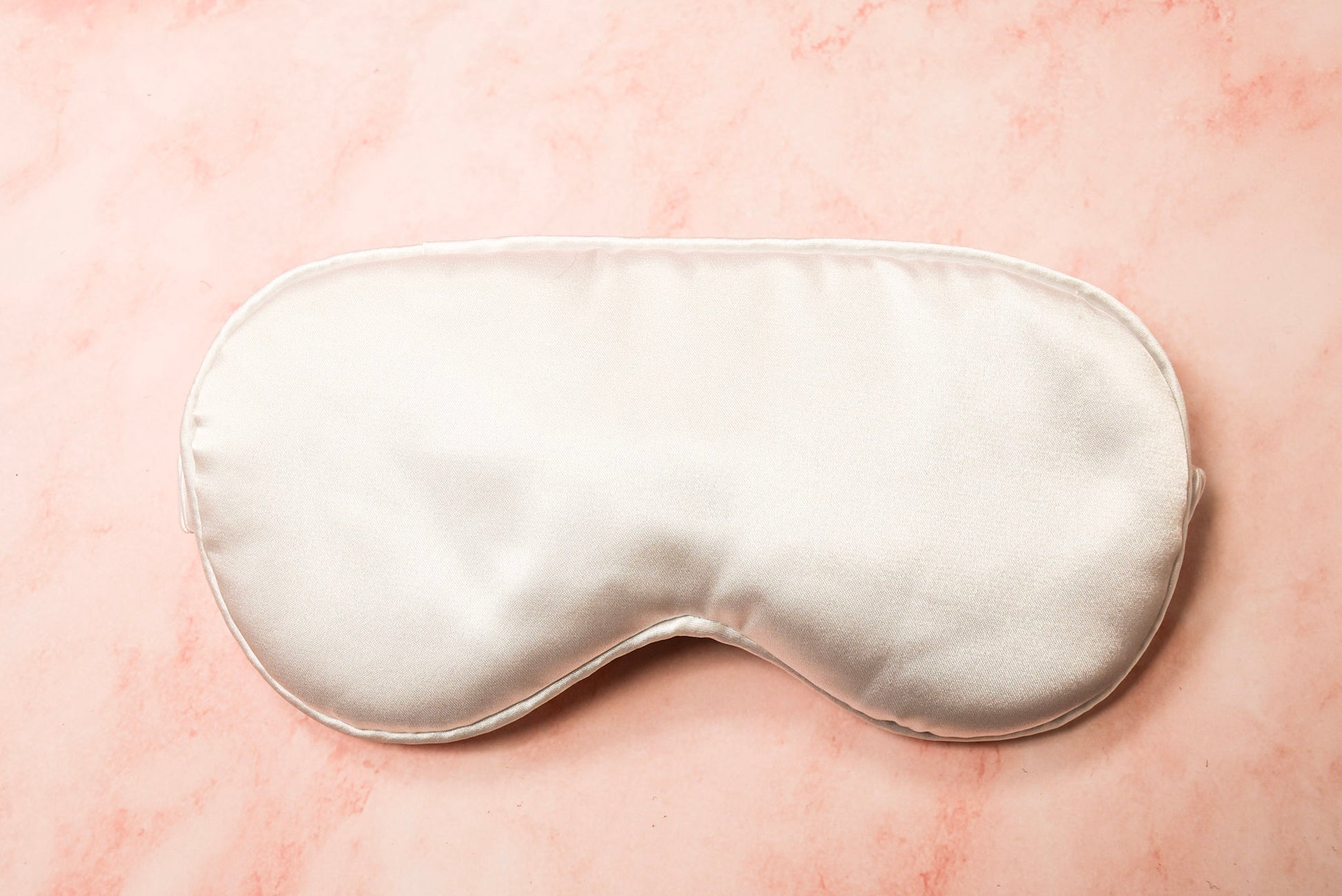 A silver silk eye mask.