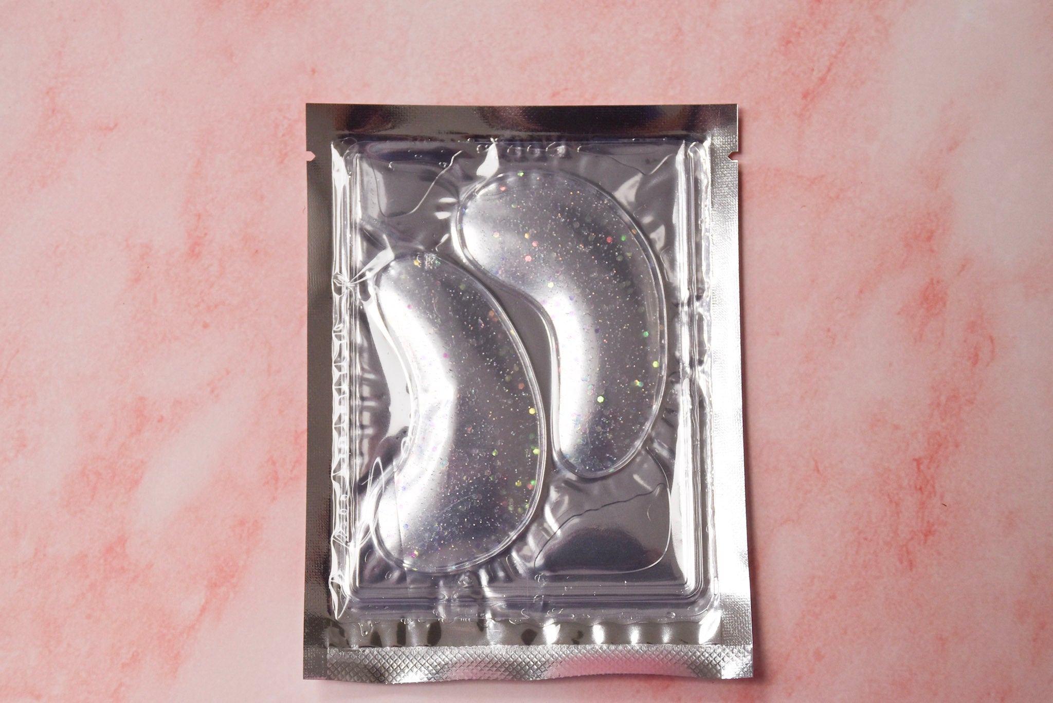 A glittery silver under eye mask.