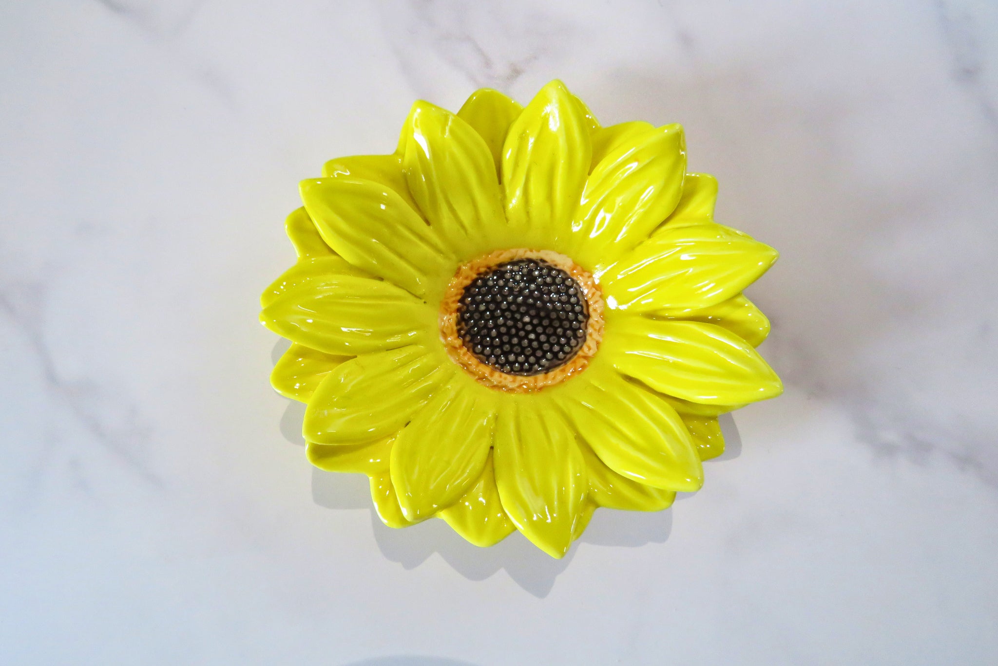 Yellow ceramic sunflower dish.