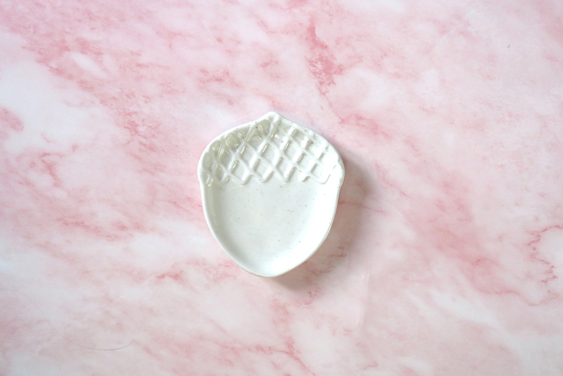 White ceramic Acorn-shaped dish.
