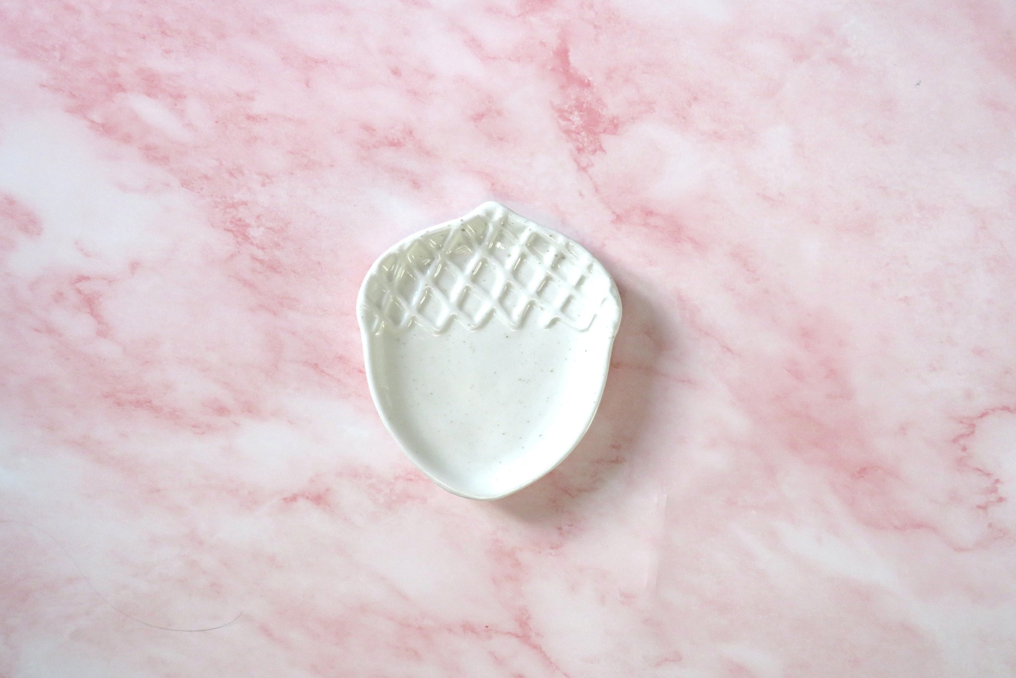 White ceramic Acorn-shaped dish.
