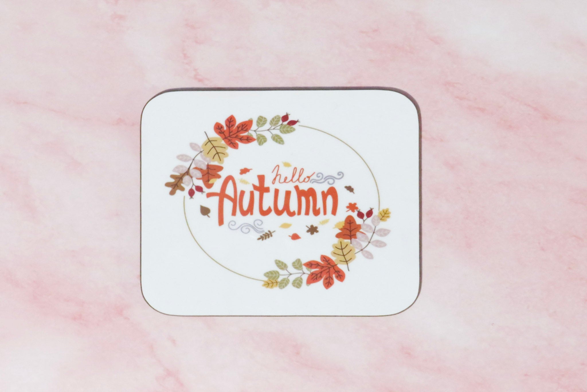 Coaster with 'Hello Autumn' text and leaf design.