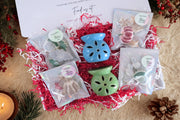 A Christmas box with scented wax melts & 2 wax burners.