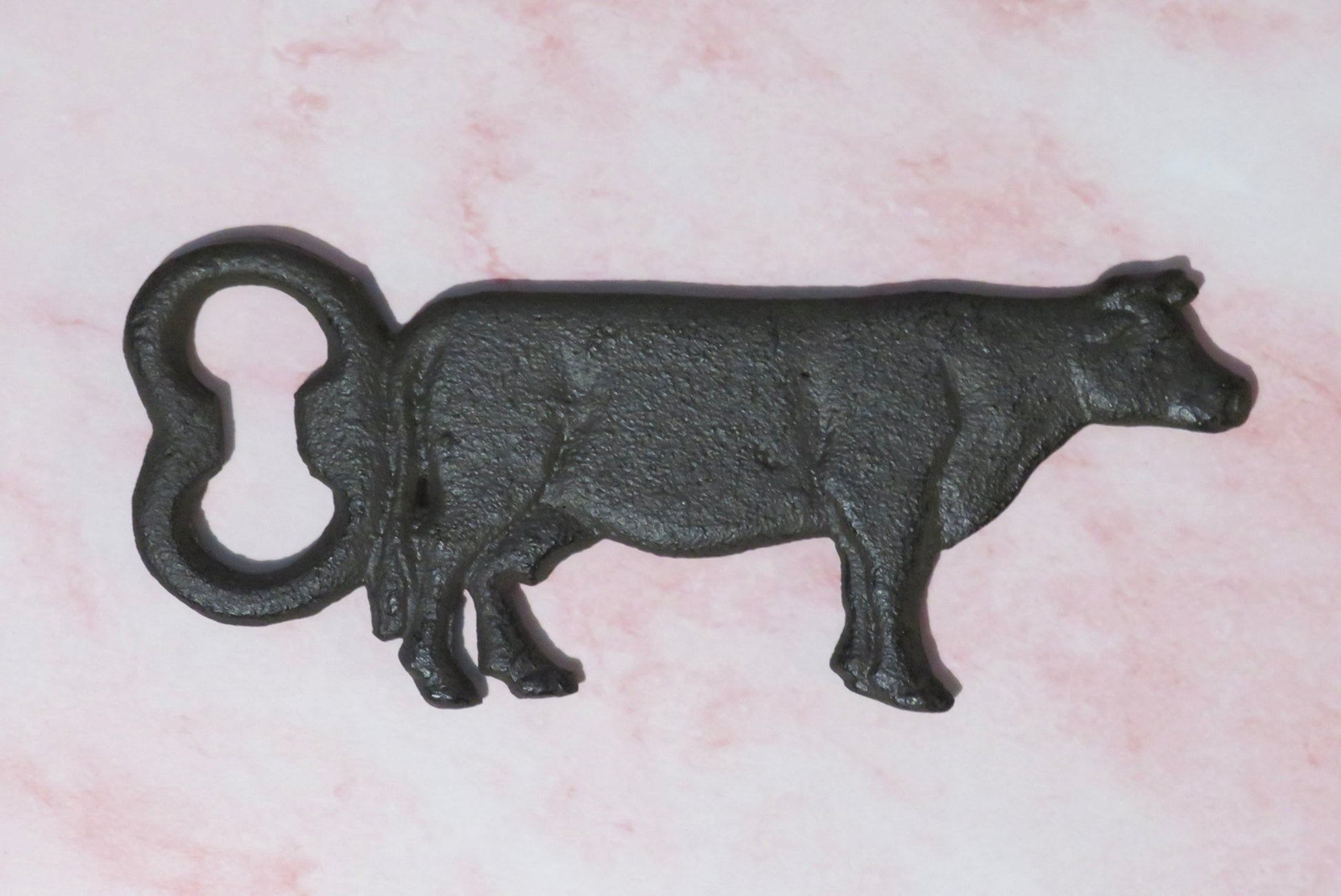 Black cast iron cow-shaped.
