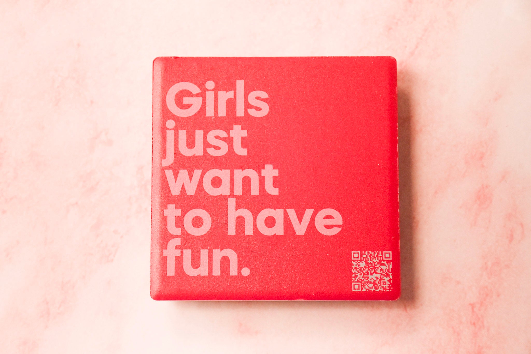 A red square magnet with white text 'Girls just want to have fun.' on it.