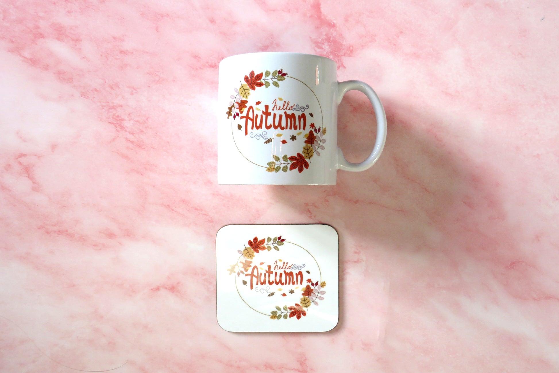White mug and coaster set with 'Autumn' design.