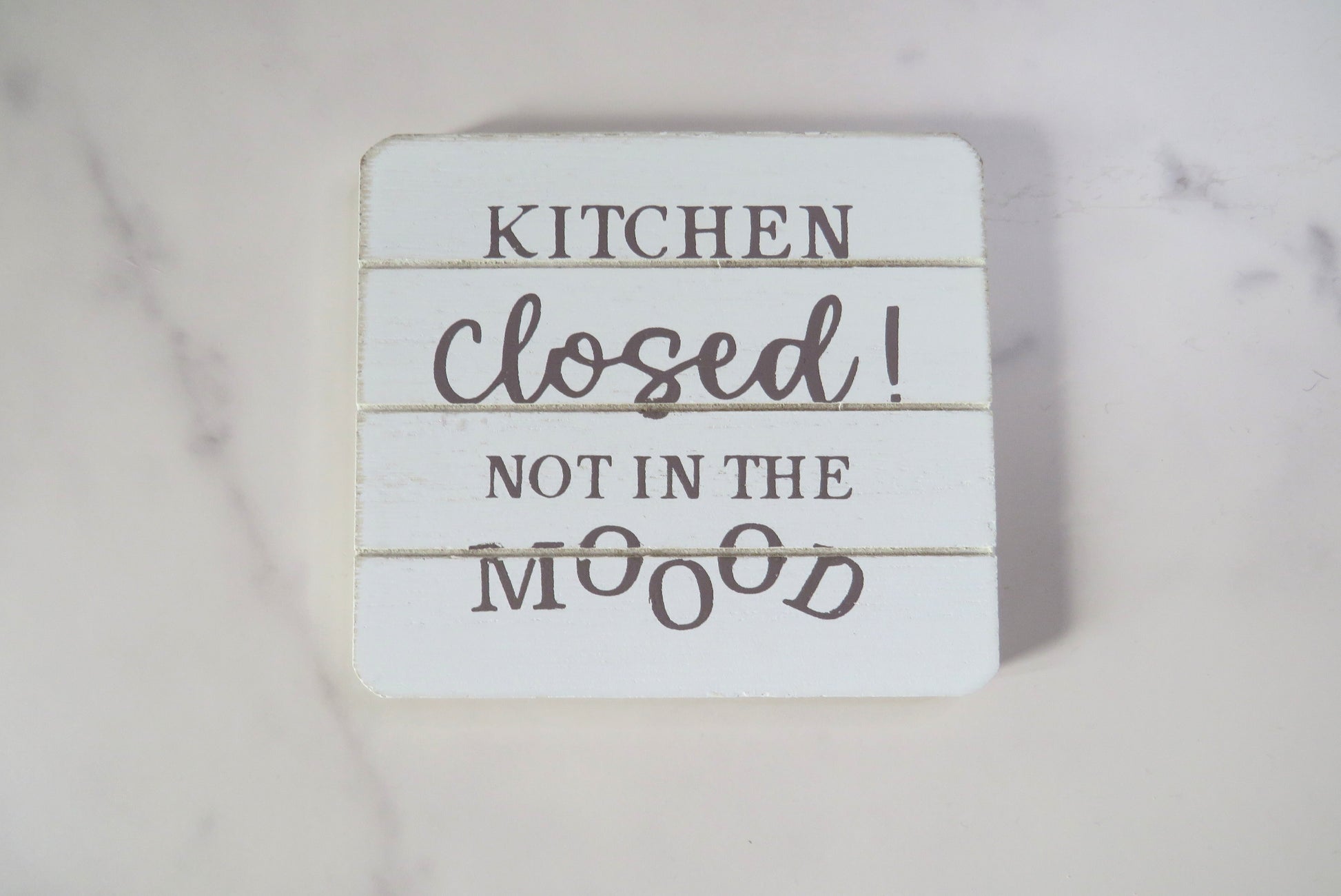 A wooden coaster with kitchen is closed not in the MOOOD text.