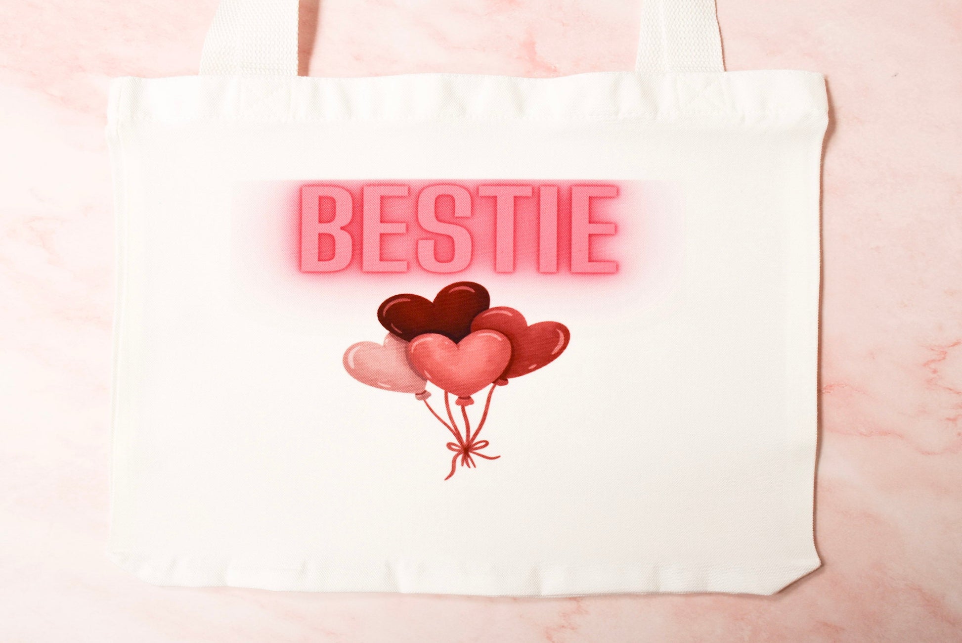 Tote bag with heart balloons and 'BESTIE' text.