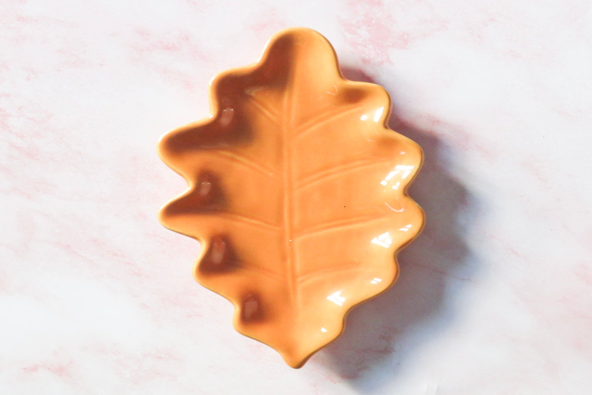 Ceramic orange leaf-shaped dish.