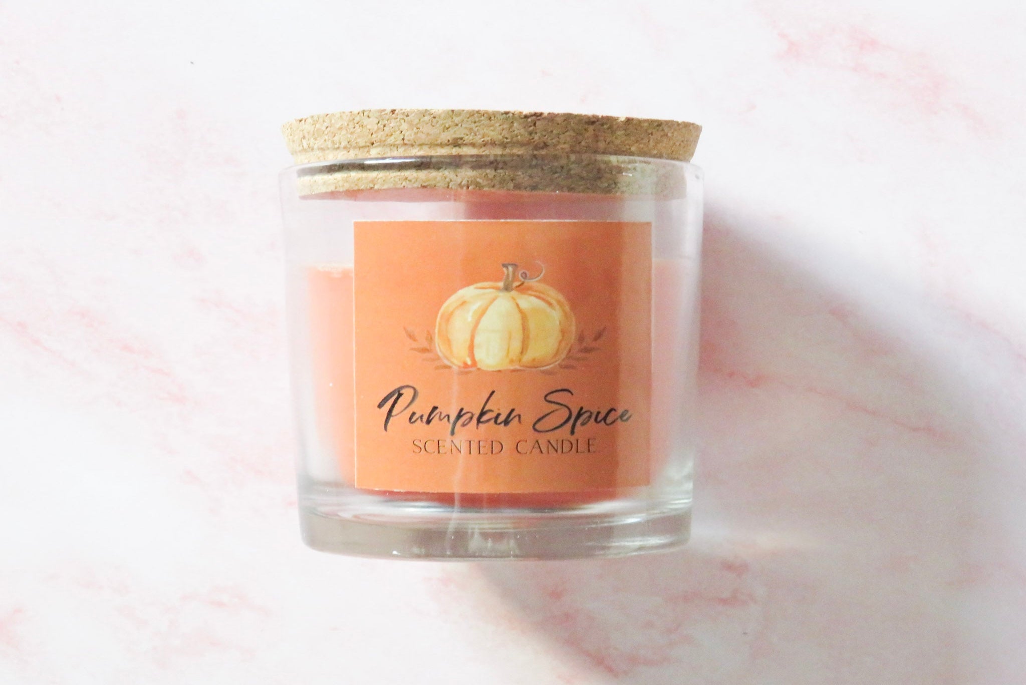 Pumpkin spice scented candle with a cork lid.