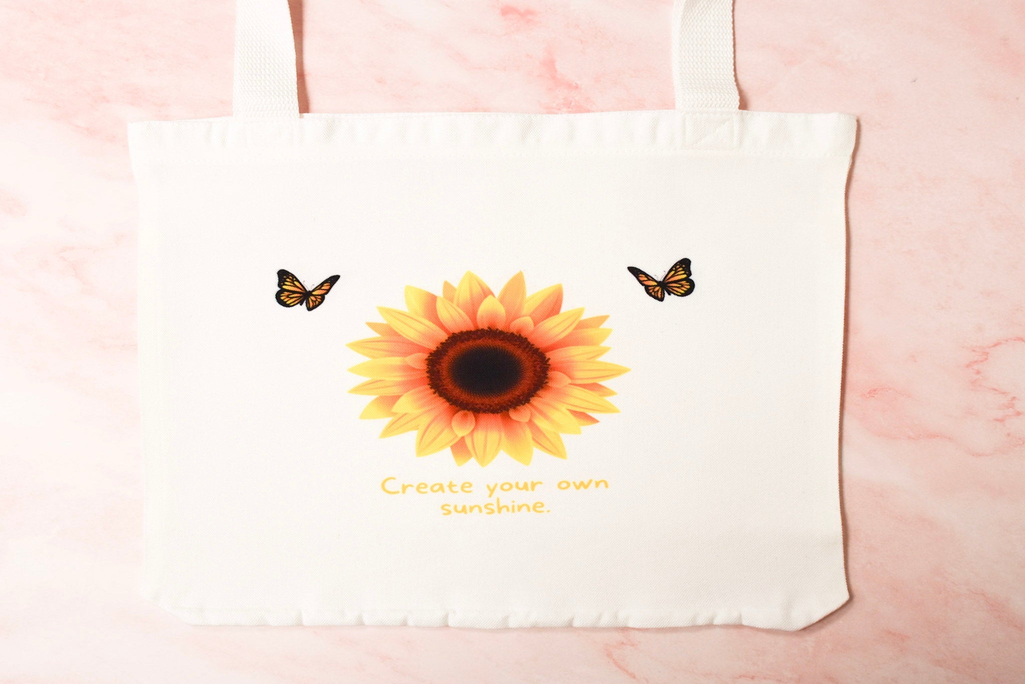 White tote bag with sunflower and butterflies design.