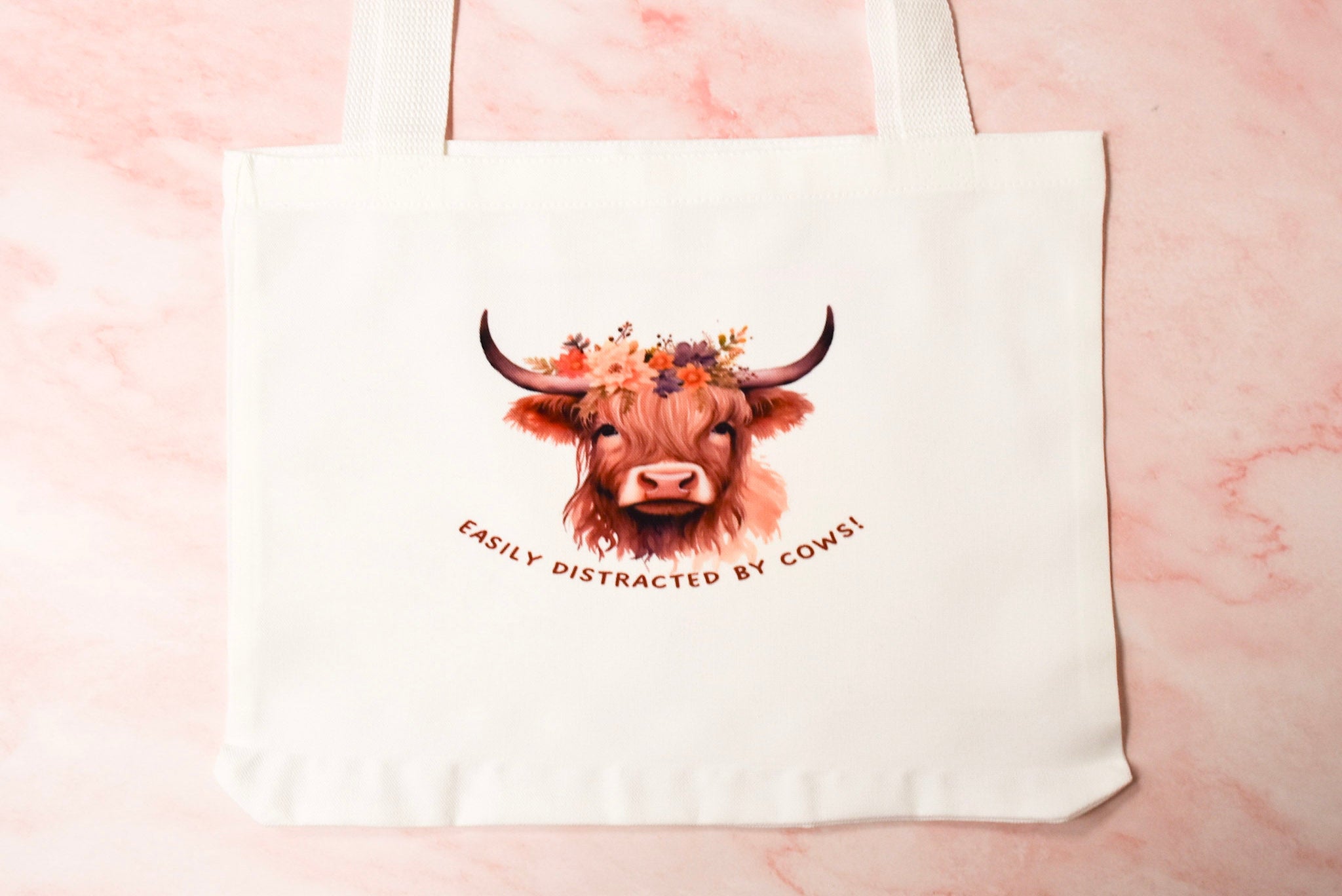 Tote bag with a highland cow design and easily distracted by cows text.